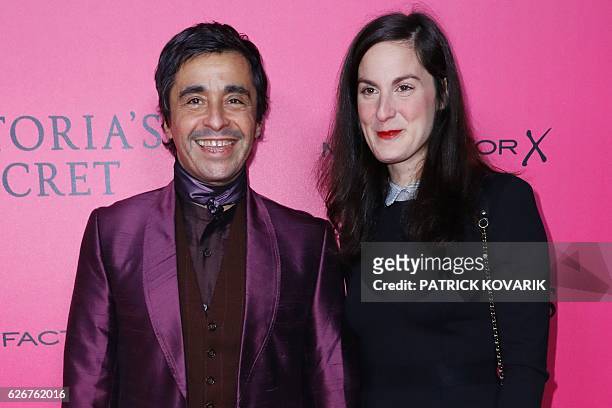 French journalist and radio host Ariel Wizman and his wife Osnath Assayag pose on the pink carpet upon their arrival for the 2016 Victoria's Secret...