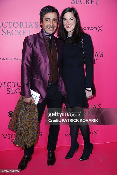 French journalist and radio host Ariel Wizman and his wife Osnath Assayag pose on the pink carpet upon their arrival for the 2016 Victoria's Secret...
