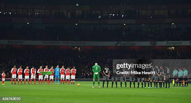 Both teams observe a minutes silence ahead of the EFL Cup quarter final match between Arsenal and Southampton at the Emirates Stadium on November 30,...