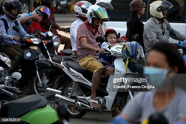 Scooters drive through the traffic on November 30, 2016 in Phnom Penh, Cambodia. Cambodia was used as a base by the North Vietnamese Army and the...
