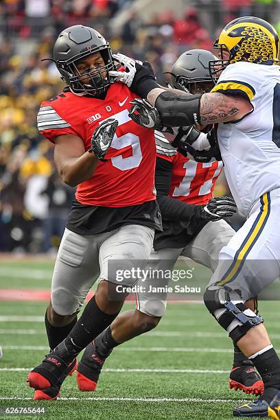 Raekwon McMillan of the Ohio State Buckeyes chases after the ballcarrier against the Michigan Wolverines at Ohio Stadium on November 26, 2016 in...