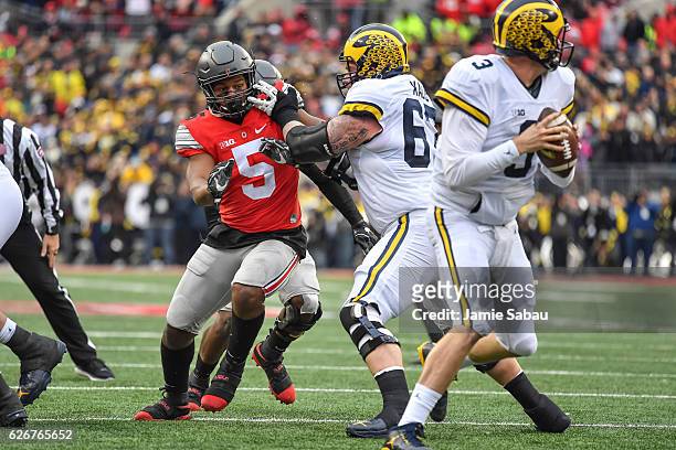 Raekwon McMillan of the Ohio State Buckeyes chases after the ballcarrier against the Michigan Wolverines at Ohio Stadium on November 26, 2016 in...