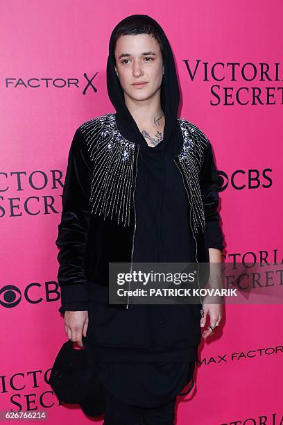 French model and DJ Agathe Mougin poses on the pink carpet upon her arrival for the 2016 Victoria's Secret Fashion Show at the Grand Palais in Paris...