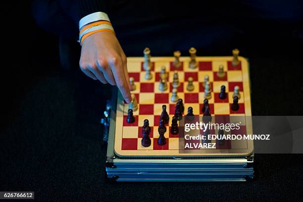 Child tries to follow the moves of Magnus Carlsen, Norwegian chess grandmaster and current World Chess Champion, and Sergey Karjakin, Russian chess...