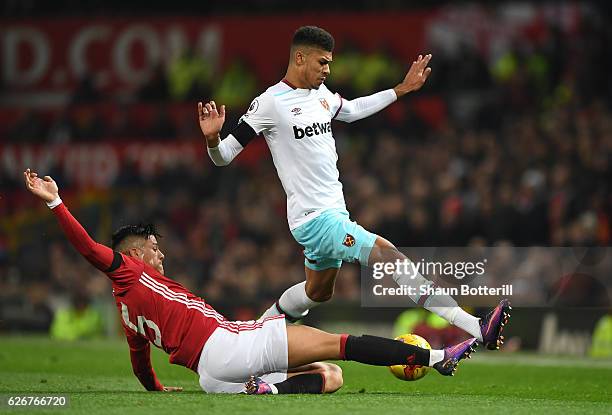 Ashley Fletcher of West Ham United is tackled by Marcos Rojo of Manchester United during the EFL Cup quarter final match between Manchester United...