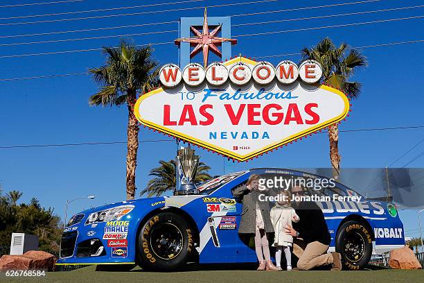 Sprint Cup Series champion Jimmie Johnson along with his daughters Genevieve Marie and Lydia Norriss pose for a photo in front of the Welcome to...