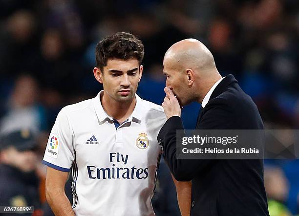 Headcoach Zinedine ZIdane speak with Enzo Zidane of Real Madrid looks on during the Copa del Rey round of 32 second leg match between Real Madrid CF...