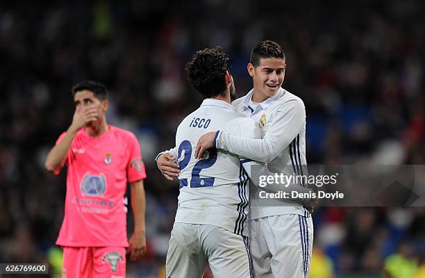 James Rodriguez of Real Madrid CF reacts with Isco after Isco narrowly failed to score a goal during the Copa del Rey last of 32 match between Real...