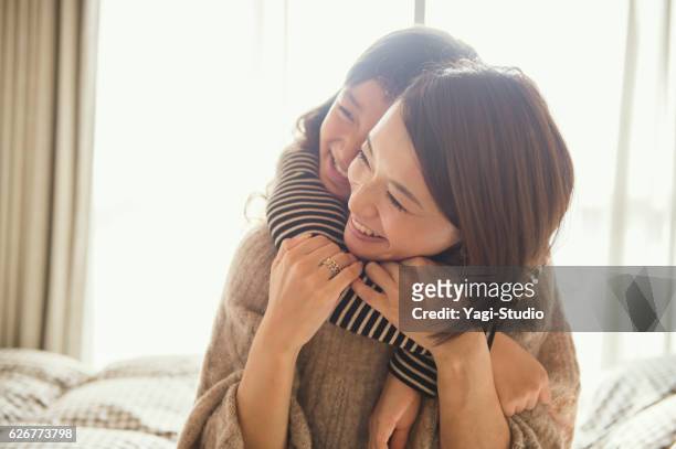 madre e hija jugando en la habitación de la cama - familia de dos generaciones fotografías e imágenes de stock