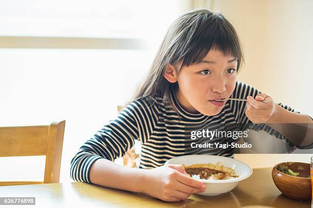 girl eating lunch in dining room - only japanese stock pictures, royalty-free photos & images