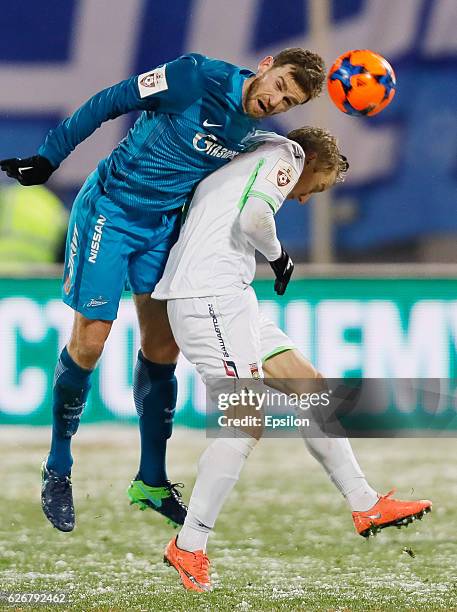 Nicolas Lombaerts of FC Zenit St. Petersburg vies for the ball with Dmitri Sysuyev of FC Ufa during the Russian Football League match between FC...