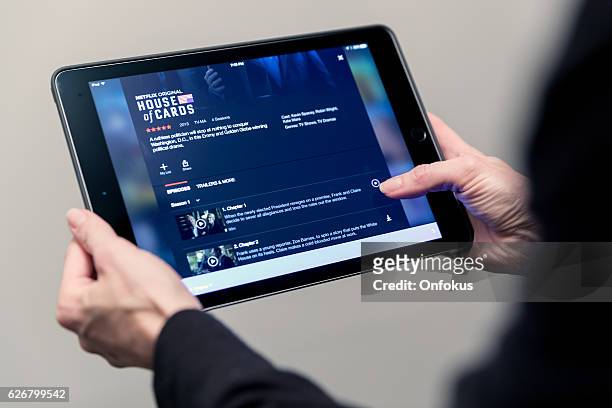 human hand holding apple ipad with netflix application - global game all access stock pictures, royalty-free photos & images