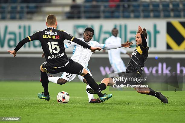 Simon Moses forward of KAA Gent is being tackled by Ingi Sverrir Ingason of sporting lokeren and Giorgos Galitsios of sporting lokeren during the...