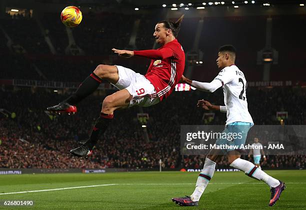 Zlatan Ibrahimovic of Manchester United beats Ashley Fletcher of West Ham to the ball during the EFL Cup Quarter-Final match between Manchester...