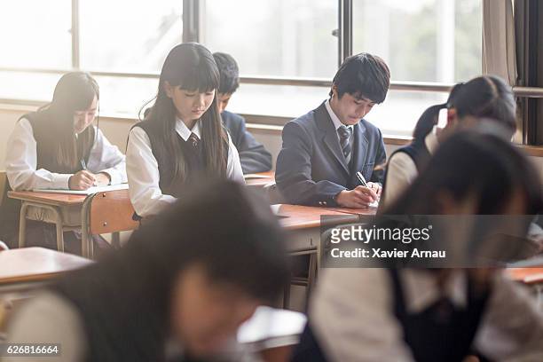 high school students studying in classroom - japanese culture stock pictures, royalty-free photos & images
