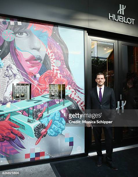 Artist Tristan Eaton poses for a photo outside the Hublot Boutique displaying a wrap created with his artwork, during the introduction of Classic...