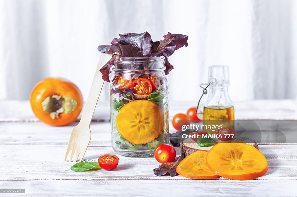 Healthy homemade Mason Jar salad with Persimmon and veggies