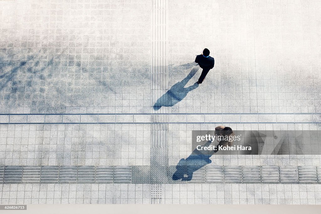 A business man and woman walking