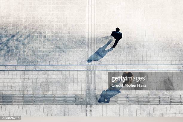 a business man and woman walking - town square top view stock pictures, royalty-free photos & images