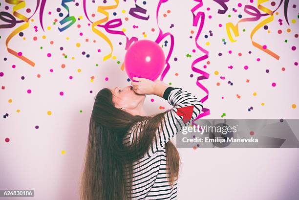 girl having fun at a birthday party - birthday streamers stock-fotos und bilder