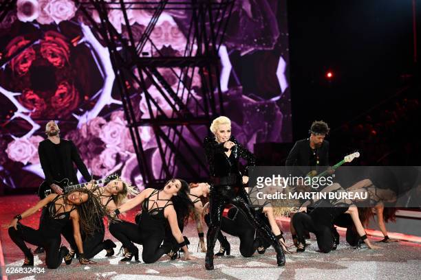 Singer Lady Gaga performs during the 2016 Victoria's Secret Fashion Show at the Grand Palais in Paris on November 30, 2016. / RESTRICTED TO EDITORIAL...