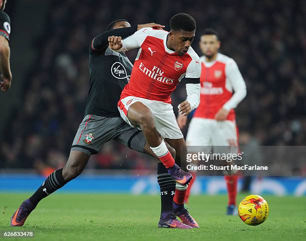 Alex Iwobi of Arsenal takes on Cuco Martina of Southampton during the EFL Quarter Final Cup match between Arsenal and Southampton at Emirates Stadium...