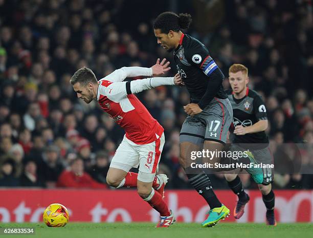 Aaron Ramsey of Arsenal holds off Virgil van Dijk of Southampton during the EFL Quarter Final Cup match between Arsenal and Southampton at Emirates...