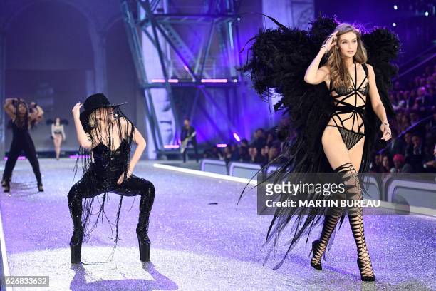 Singer Lady Gaga performs while US model Gigi Hadid presents a creation during the 2016 Victoria's Secret Fashion Show at the Grand Palais in Paris...