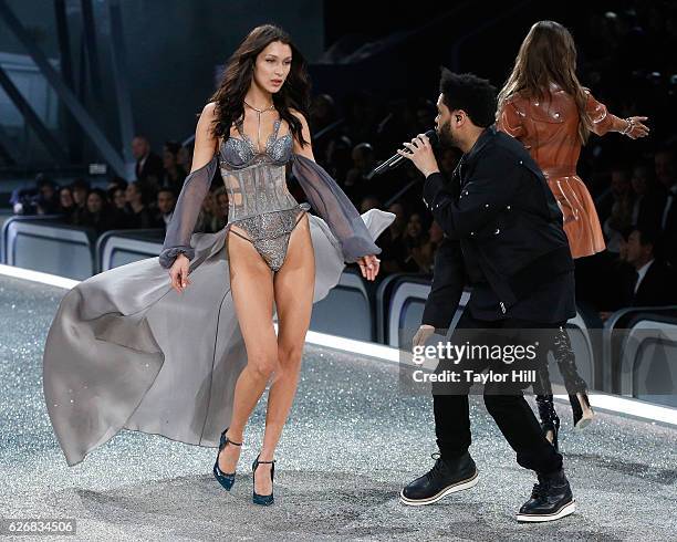 The Weeknd performs as Bella Hadid walks the runway during the 2016 Victoria's Secret Fashion Show at Le Grand Palais on November 30, 2016 in Paris,...