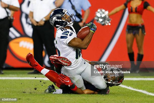 Seattle Seahawks punt returner Tyler Lockett is tackled by Tampa Bay Buccaneers defensive back Josh Robinson after returning a punt during the NFL...