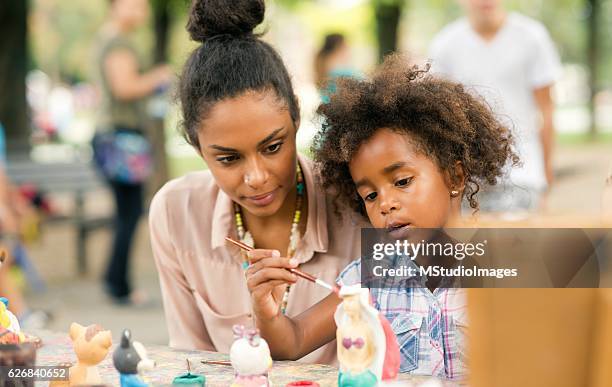 painting a sculpture. - kids art stockfoto's en -beelden