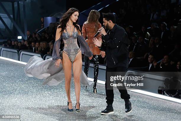 The Weeknd performs as Bella Hadid walks the runway during the 2016 Victoria's Secret Fashion Show at Le Grand Palais on November 30, 2016 in Paris,...