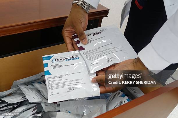Hansel Tookes, a doctor at the University of Miami, holds HIV tests on November 30 that will be given away for free to drug users at a new syringe...