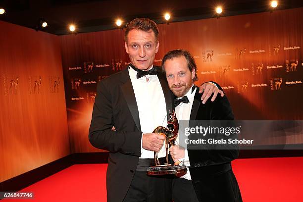 Oliver Masucci and Fabian Busch with award ' Er ist wieder da' during the Bambi Awards 2016 at winners board at Stage Theater on November 17, 2016 in...