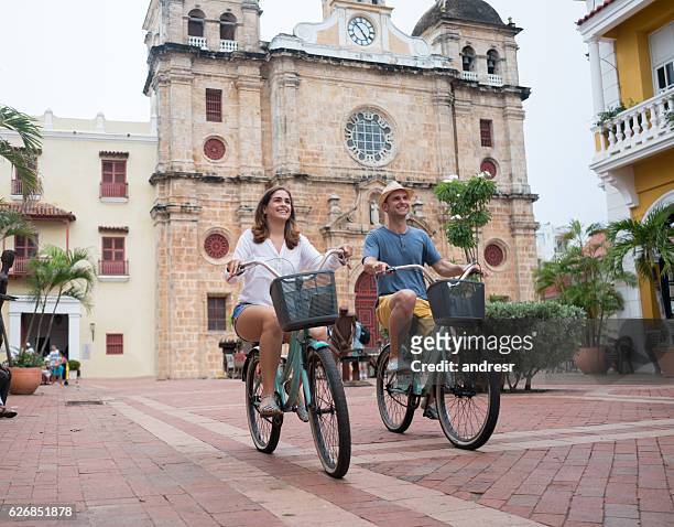 couple sightseeing on bikes in cartagena - cartagena colombia stock pictures, royalty-free photos & images