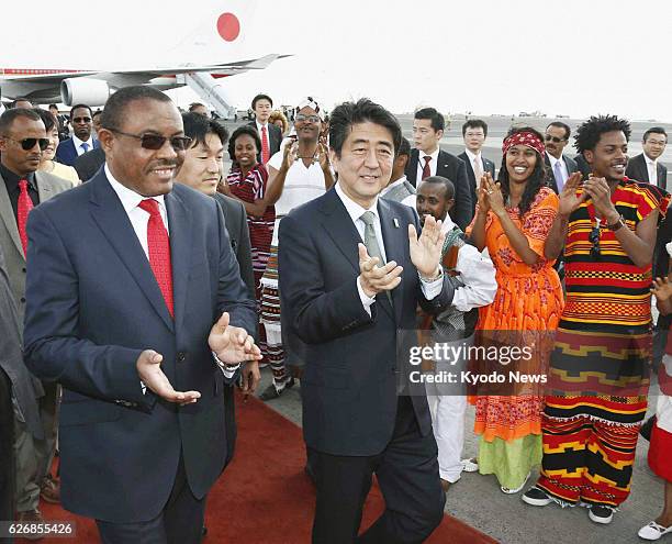 Ethiopia - Japanese Prime Minister Shinzo Abe is greeted by Ethiopian Prime Minister Hailemariam Desalegn and others after arriving at Bole airport...