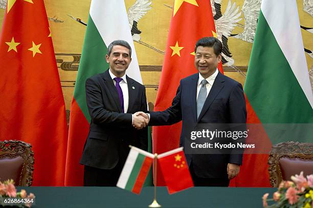 China - Bulgarian President Rossen Plevneliev and Chinese President Xi Jinping shake hands after a signing ceremony at the Great Hall of the People...