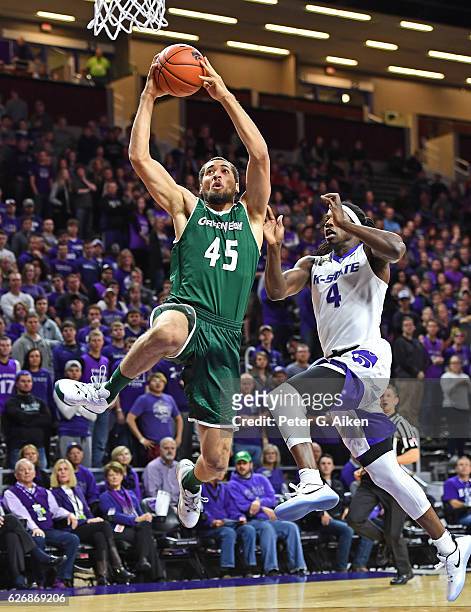 Forward Kenneth Lowe of the Wisconsin-Green Bay Phoenix drives to the basket against forward D.J. Johnson of the Kansas State Wildcats during the...