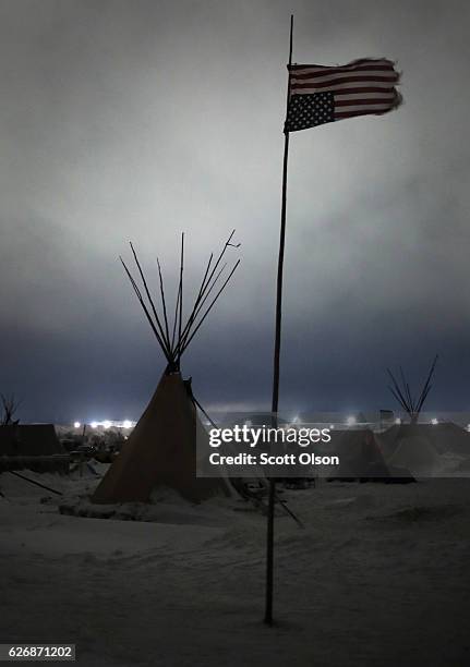 An upside down American flag flies above Oceti Sakowin Camp on the edge of the Standing Rock Sioux Reservation on November 30, 2016 outside Cannon...