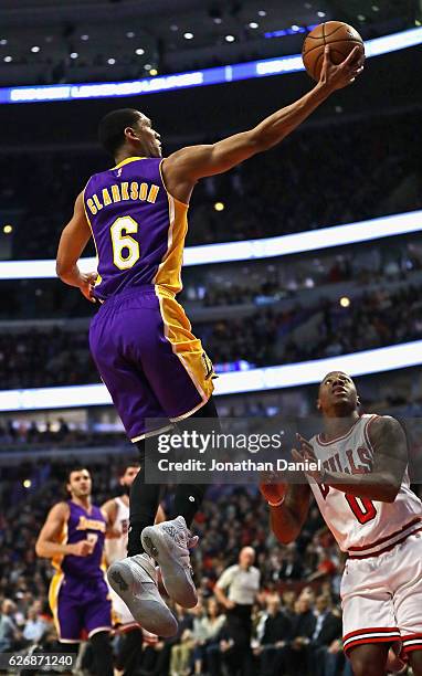 Jordan Clarkson of the Los Angeles Lakers puts up a shot over Isaiah Canaan of the Chicago Bulls at the United Center on November 30, 2016 in...