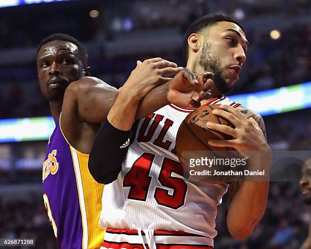 Denzel Valentine of the Chicago Bulls and Luol Deng of the Los Angeles Lakers get tangled up at the United Center on November 30, 2016 in Chicago,...
