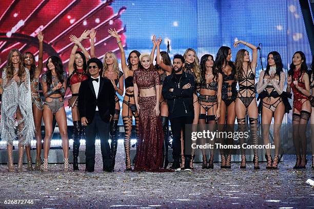 Bruno Mars, Lady Gaga, The Weeknd, Adriana Lima, Lily Aldridge, and models pose on the runway after the 2016 Victoria's Secret Fashion Show at the...