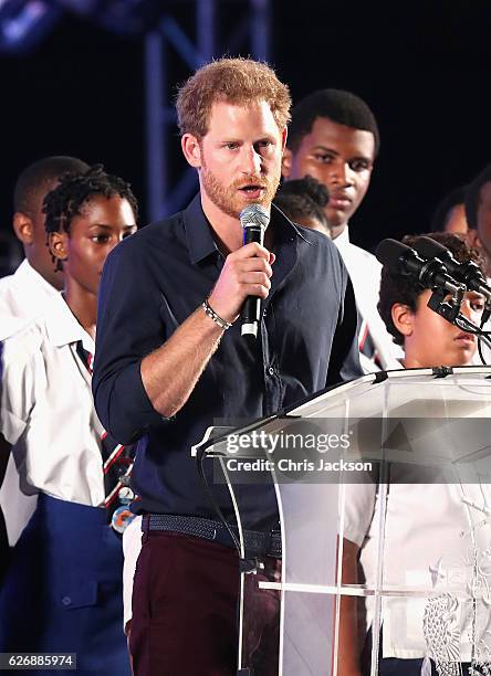 Prince Harry gives a speech as he attends a Golden Anniversary Spectacular Mega Concert at the Kensington Oval Cricket Ground on day 10 of an...