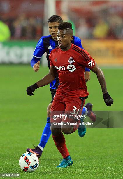Armando Cooper of Toronto FC and Johan Venegas of Montreal Impact battle for the ball during the second half of the MLS Eastern Conference Final, Leg...
