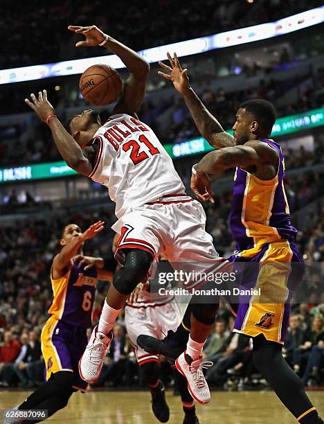 Jimmy Butler of the Chicago Bulls looses control of the ball after being fouled by Thomas Robinson of the Los Angeles Lakers at the United Center on...