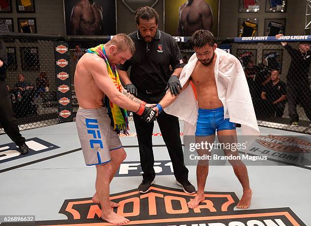 Tim Elliot shakes hands with Hiromasa Ogikubo during the filming of The Ultimate Fighter: Team Benavidez vs Team Cejudo at the UFC TUF Gym on August...