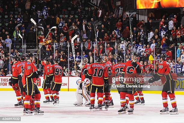 The Calgary Flames salute the crowd after their victory over the Toronto Maple Leafs during an NHL game at Scotiabank Saddledome on November 30, 2016...