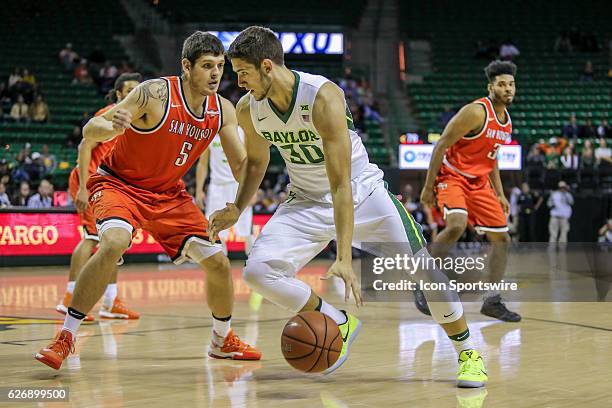 Baylor Bears forward Jonathan Davis is guarded by Sam Houston State Bearkats forward Jesse Lopez Jr. During the NCAA basketball game between Baylor...