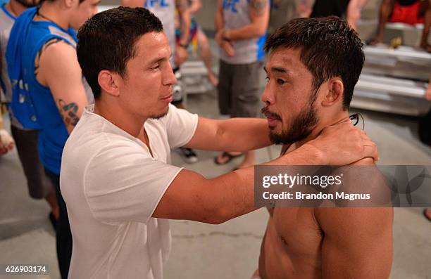 Head coach Joseph Benavidez consoles Hiromasa Ogikubo after facing Tim Elliot during the filming of The Ultimate Fighter: Team Benavidez vs Team...