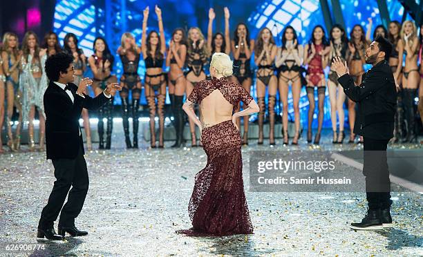 Bruno Mars, Lady Gaga and The Weeknd walk the runway as model look on during the annual Victoria's Secret fashion show at Grand Palais on November...